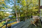 Deck features gas grill, large picnic table and Adirondacks